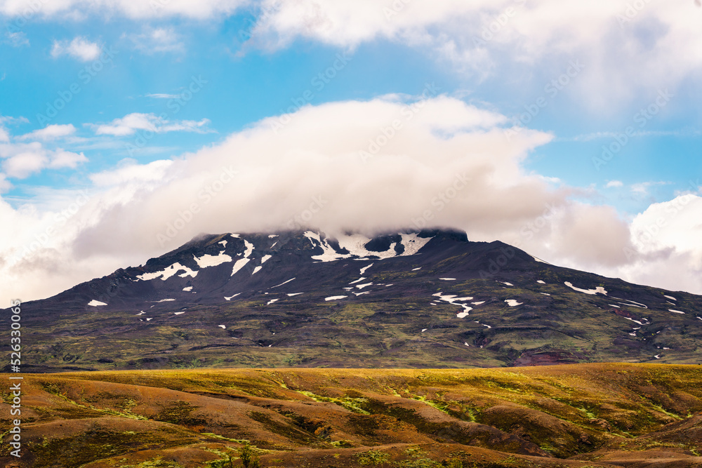 Fototapeta premium Natural pileus cloud covered on volcanic mountainin Icelandic Highlands on daylight at Thorsmork, Iceland