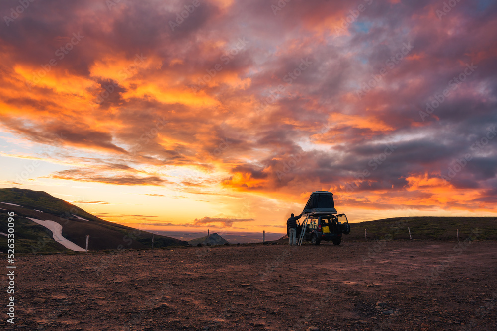 Camper car parked with sunset sky on top of mountain in Icelandic Highlands on summer at Iceland