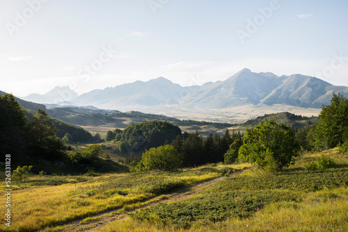 Landscape, view of the Gran Sasso plateau during sunset. Green valley and mountain peaks