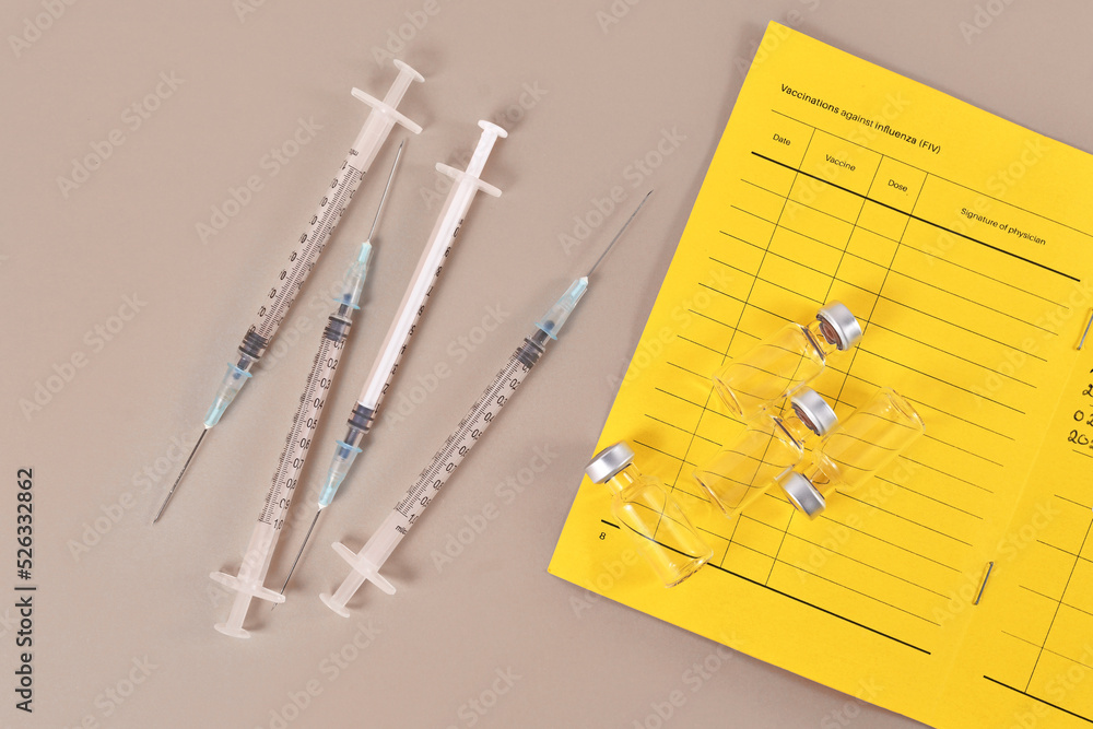 Concept for Corona virus booster vaccination showing vaccine passport with 4 syringes and vials - obrazy, fototapety, plakaty 