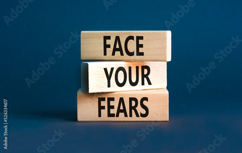 Face your fears and support symbol. Concept words Face your fears on wooden blocks. Beautiful grey table grey background. Business and Face your fears quote concept. Copy space. © Dzmitry