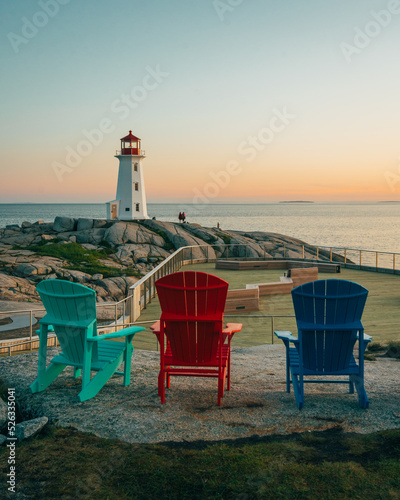 Obraz na płótnie Peggys Cove Lighthouse with Adirondack chairs at sunset, Peggys Cove, Nova Scotia, Canada w salonie