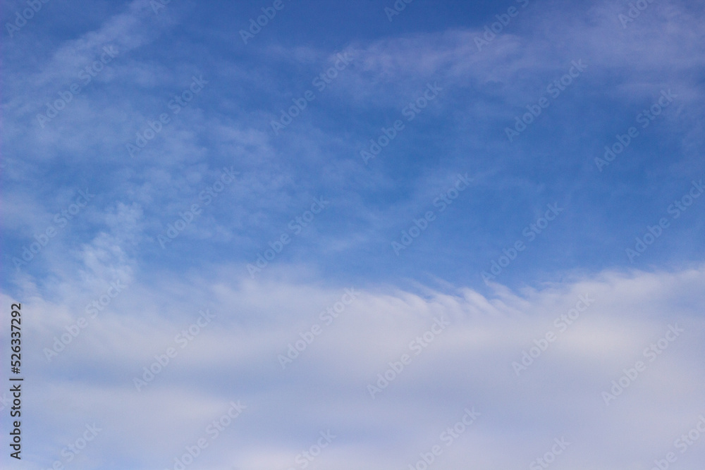 Beautiful sky with white clouds background. Light cumulus clouds in the blue sky