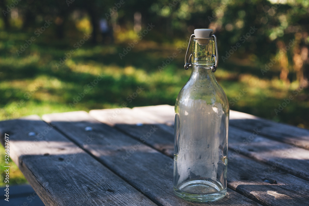 bottle of water on a table in apple garden bottle of water on a table in apple garden