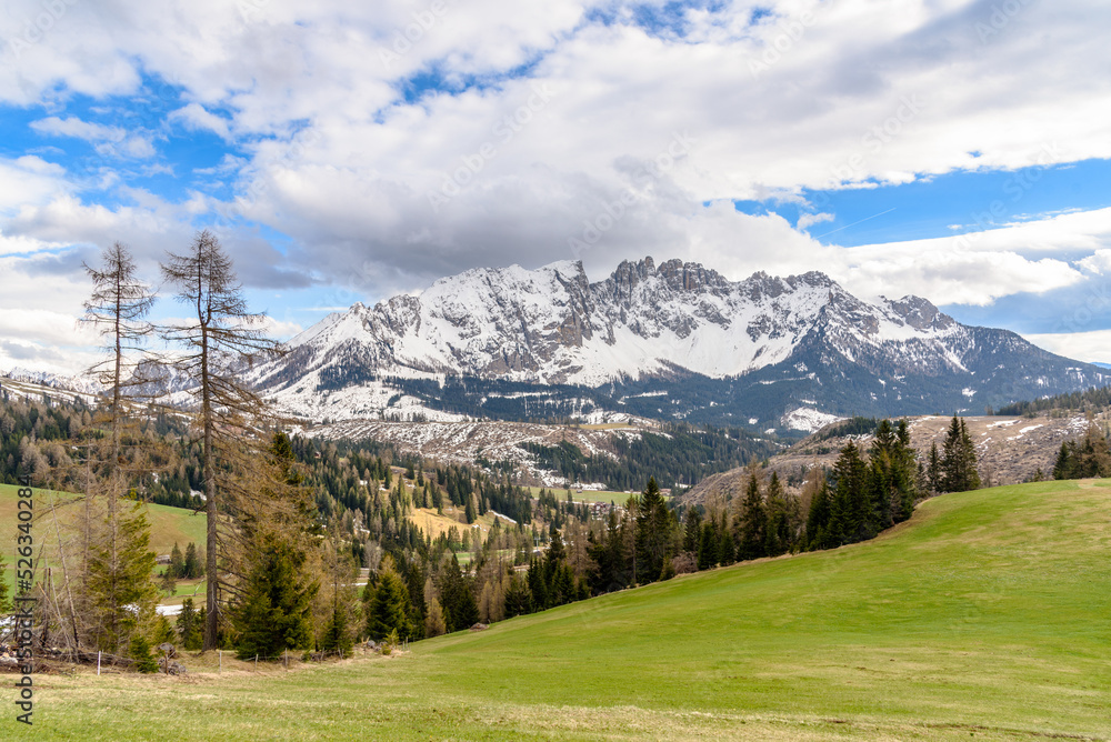 Majestic snow-capped peaks in the European Alps on a cloudy spring day.