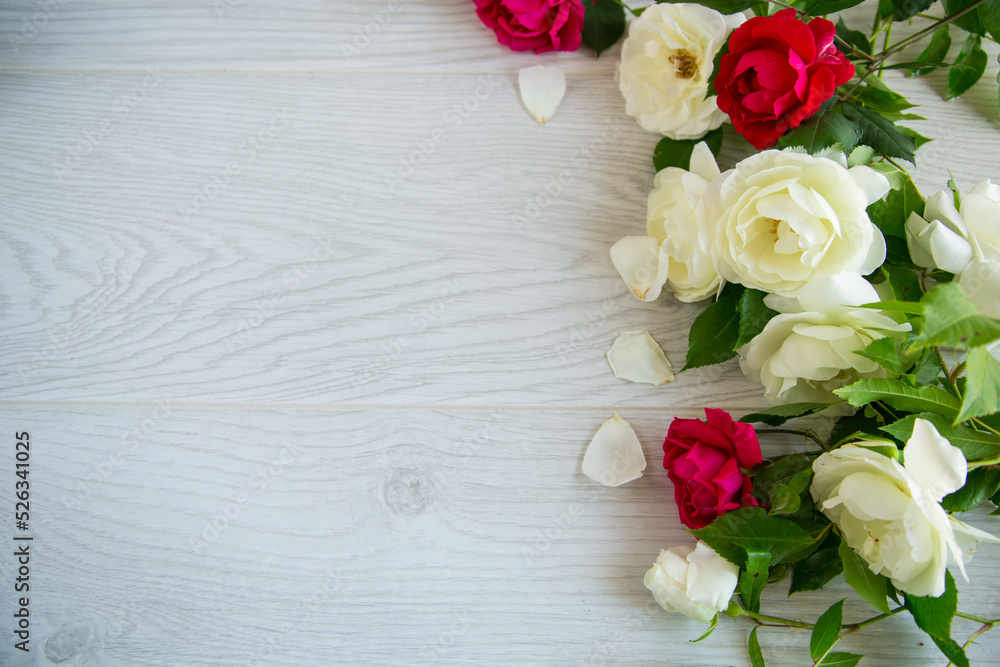 background of many red roses on a light wooden background of many red roses on a light wooden