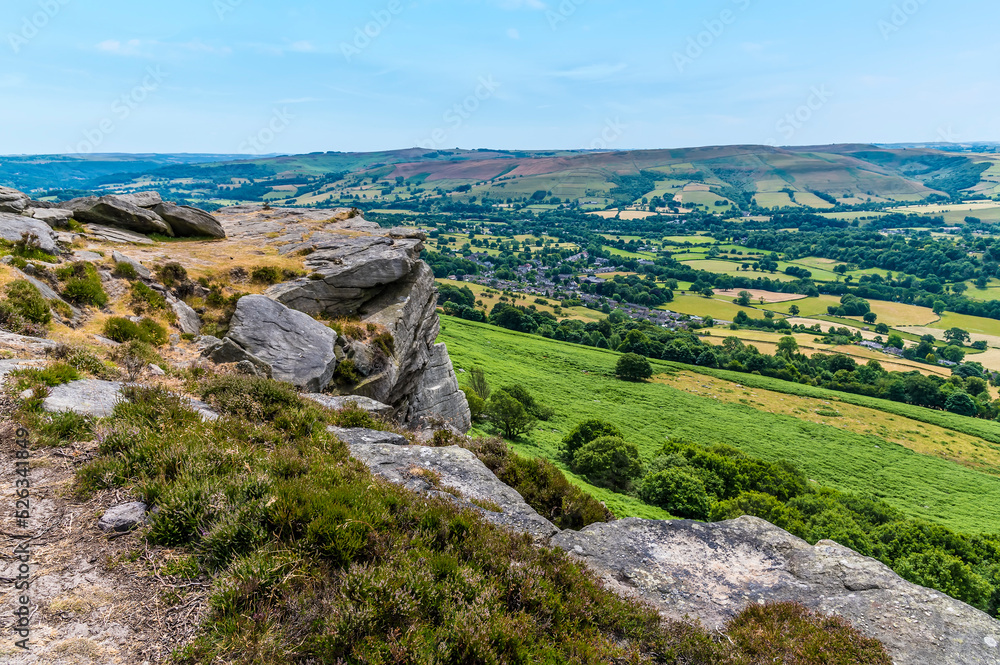 A view down towards the Hope Valley from the rocky top of Bamford Edge, UK in summertime