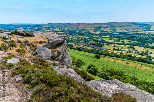 A view down towards the Hope Valley from the rocky top of Bamford Edge  UK in summertime