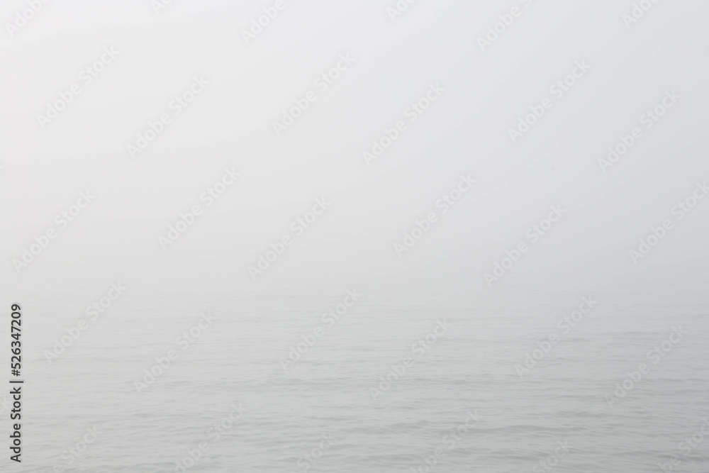 Seascape in fog. Abstract background in the form of a grey sea in the fog. Free space for text.