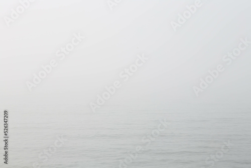 Seascape in fog. Abstract background in the form of a grey sea in the fog. Free space for text.