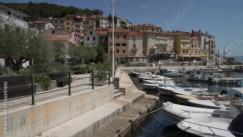 Boats in the harbour and restaurants and bars lining the sea front, Moscenicka Draga, Kvarner Bay photo