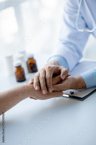 Doctor shook hands to encourage the patient after informing the results of the examination and informing the patients about treatment guidelines and prescribing medicines. Disease examination concept.