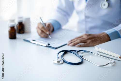 close up, the doctor's stethoscope is placed on the doctor's desk in the hospital examination room, the concept of treatment and symptomatic medication dispensing by the pharmacist.
