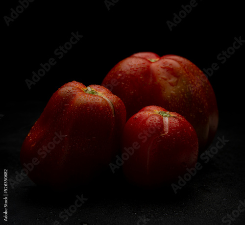 Red fresh Tomatoes on black background