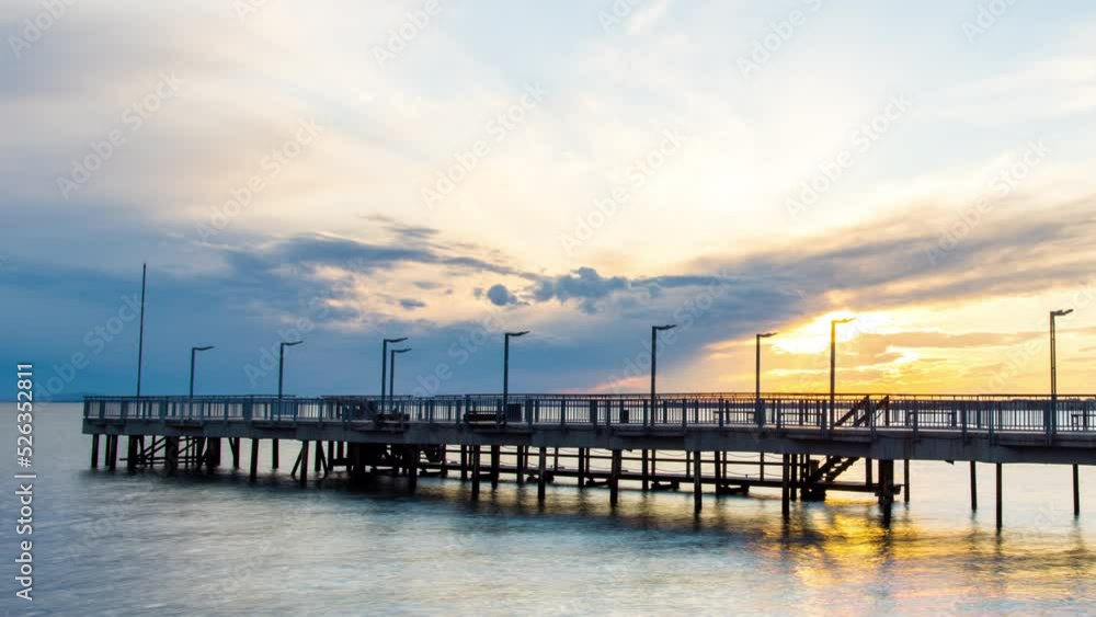 Side view of the pier on the Black Sea against the background of the sky and sunset Side view of the pier on the Black Sea against the background of the sky and sunset