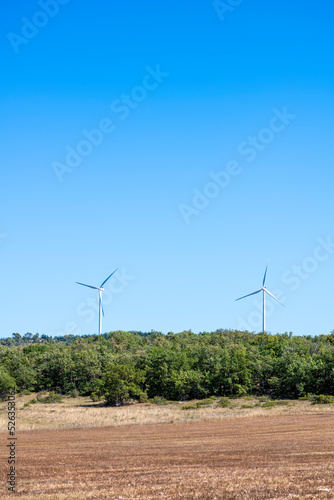 Onshore horizontal axis wind turbines in South of France, Europe. Vertical shot with copy space allowing seamless integration of your custom text, titles, headings, or graphic elements photo