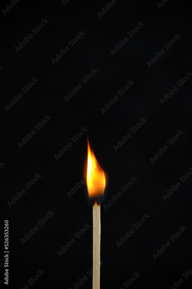 Standing, burning match on a black background. Standing, burning match on a black background.