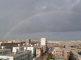 Real Rainbow Over City In Morning. Real Rainbow with Cloudy weather