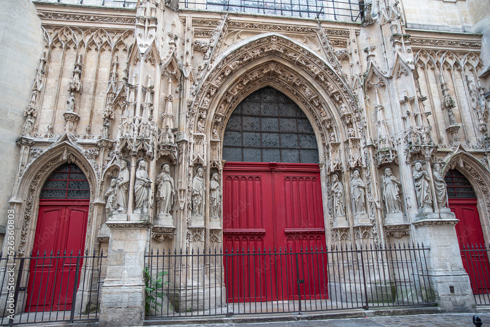 Detail of the red wooden portal of a church in Paris, France