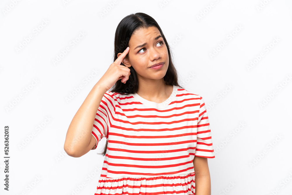 Young Colombian woman isolated on white background making the gesture of madness putting finger on the head Young Colombian woman isolated on white background making the gesture of madness putting finger on the head
