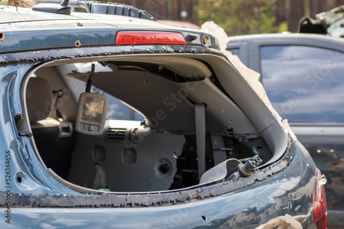 A car after an accident with a broken rear window. Broken window in a vehicle. The wreckage of the interior of a modern car after an accident, a detailed close-up view of the damaged car. © Yevhen Roshchyn