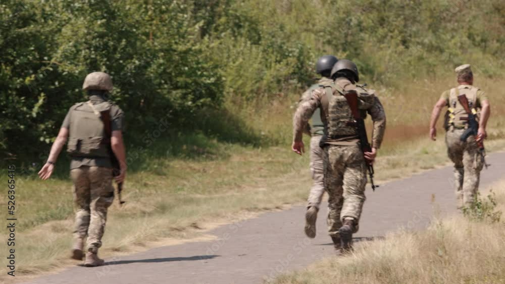 Armed soldiers running forward during military operations Armed soldiers running forward during military operations
