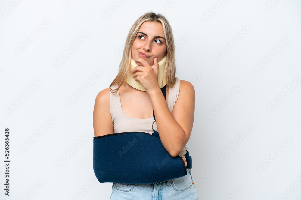 Woman with broken arm and wearing a sling isolated on white background and looking up Woman with broken arm and wearing a sling isolated on white background and looking up