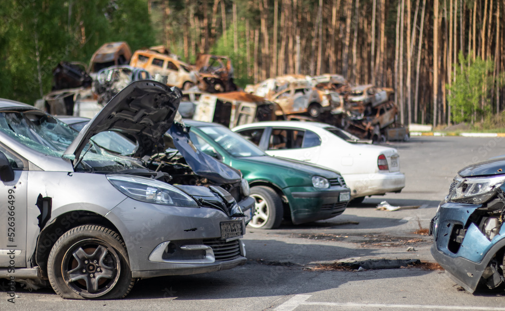 Shot, damaged cars during the war in Ukraine. The civilian car was damaged. Shrapnel and bullet holes in the car body. Car riddled with bullets. Bullet holes and shell fragments.