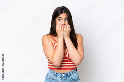 Young Brazilian woman isolated on white background nervous and scared putting hands to mouth