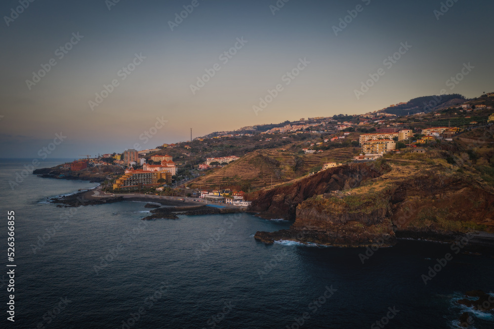 Coastline of Canico de Baixo and hotels at sunrise. Madeira, october 2021. Aerial drone picture