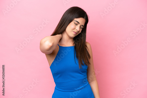Young Brazilian woman isolated on pink background with neckache