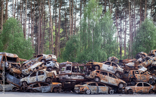 A lot of rusty burnt cars in Irpen, after being shot by the Russian military. Russia's war against Ukraine. Cemetery of destroyed cars of civilians who tried to evacuate from the war zone. photo