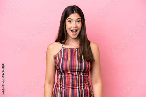 Young Brazilian woman isolated on pink background with surprise facial expression