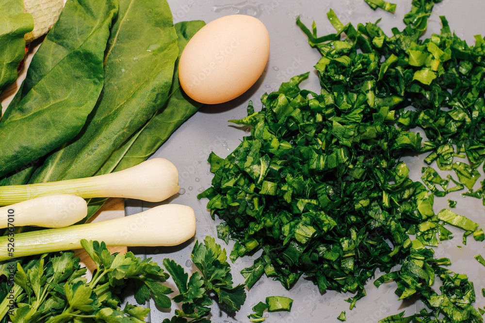 Young green chopped greens close-up, sour sorrel, eggs and onions. Young green chopped greens close-up, sour sorrel, eggs and onions.