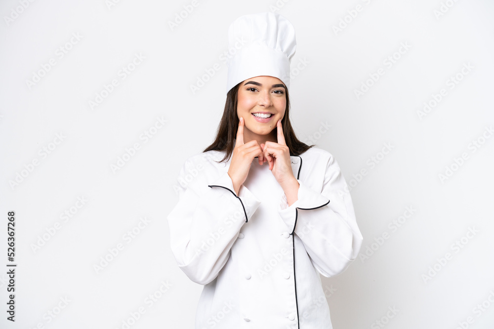 Young Brazilian chef woman isolated on white background smiling with a happy and pleasant expression Young Brazilian chef woman isolated on white background smiling with a happy and pleasant expression
