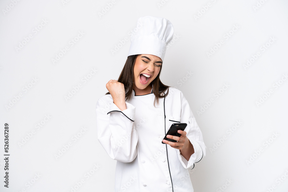 Young Brazilian chef woman isolated on white background with phone in victory position Young Brazilian chef woman isolated on white background with phone in victory position