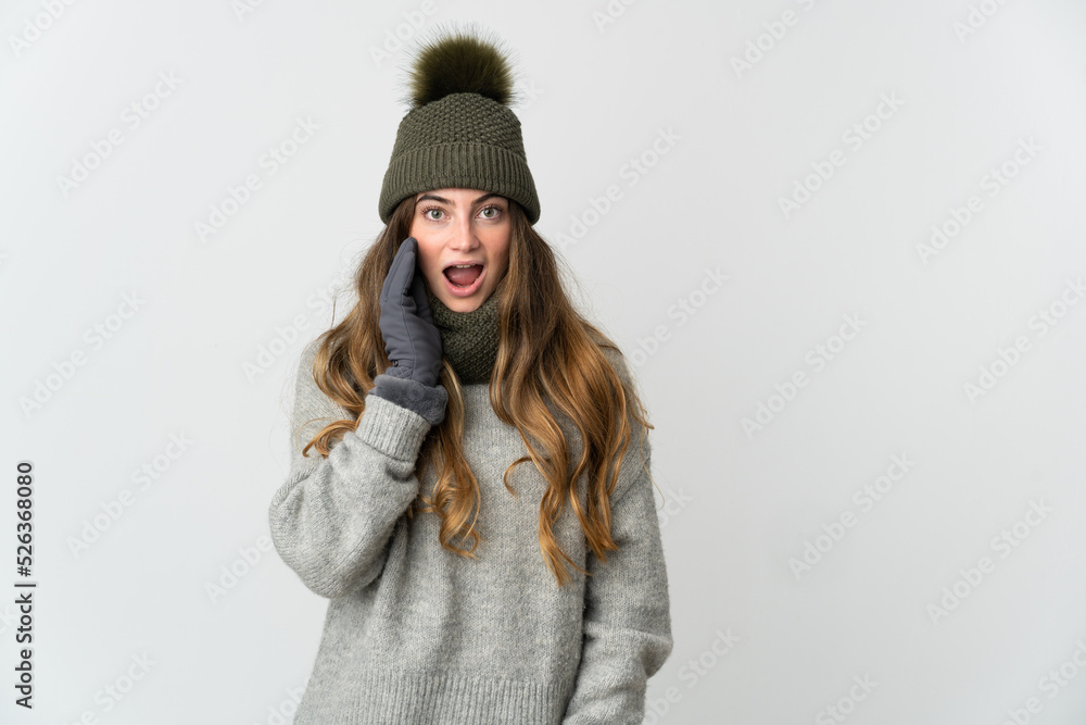 Young caucasian woman with winter hat isolated on white background with surprise and shocked facial expression Young caucasian woman with winter hat isolated on white background with surprise and shocked facial expression
