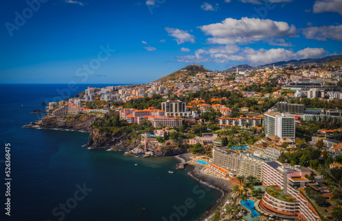 Scenery around Funchal, a city of the portuguese island named Madeira. View on harbour from the ocean. Aerial drone shot. October 2021