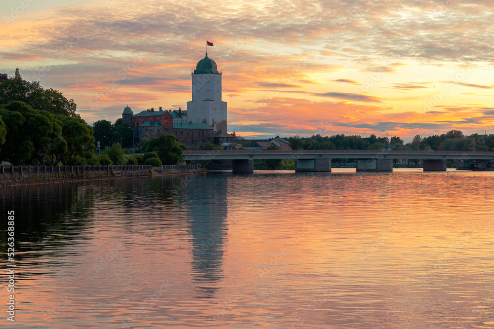 The view of Vyborg castle against the sunset sky on summer evening