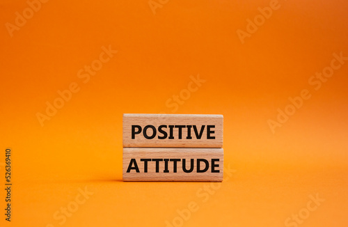 Positive attitude symbol. Concept words Positive attitude on wooden blocks. Beautiful orange background. Business and Positive attitude concept. Copy space.