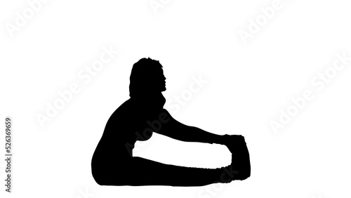 Silhouette of young woman practicing yoga 