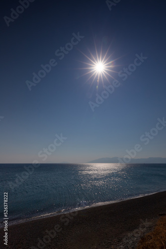 Fototapeta Naklejka Na Ścianę i Meble -  Krajobraz morski. Minimalistyczny krajobraz z niebieskim niebem i słońcem w kształcie gwiazdy.
