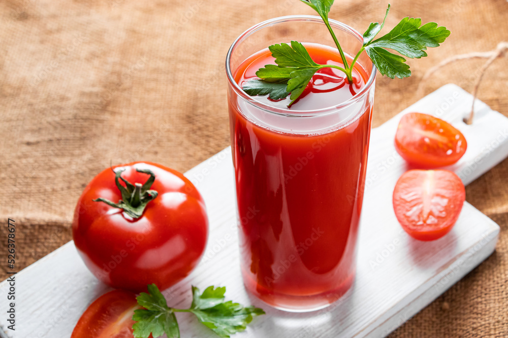 Dietary tomato juice on linen background. Healthy drink made from farm vegetables. Dietary tomato juice on linen background. Healthy drink made from farm vegetables.