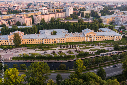 Aerial view of the public park of the Karpovka River Embankment in St. Petersburg at sunset, Russia, recreation areas, benches and amphitheater, botanical garden opposite the park