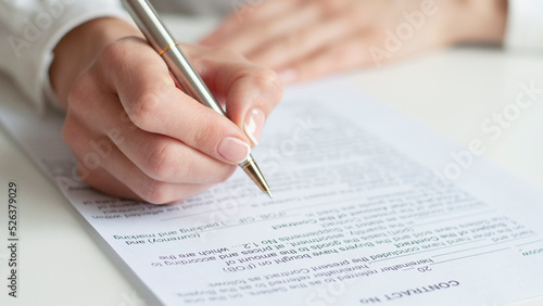 close up of a woman signing contract