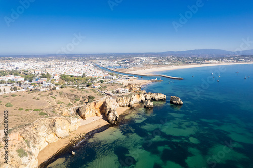 Ponta da Piedade with over rocks near Lagos in Algarve, Portugal. Ponta da Piedade, Algarve region, Portugal. Beach Tourists Umbrellas