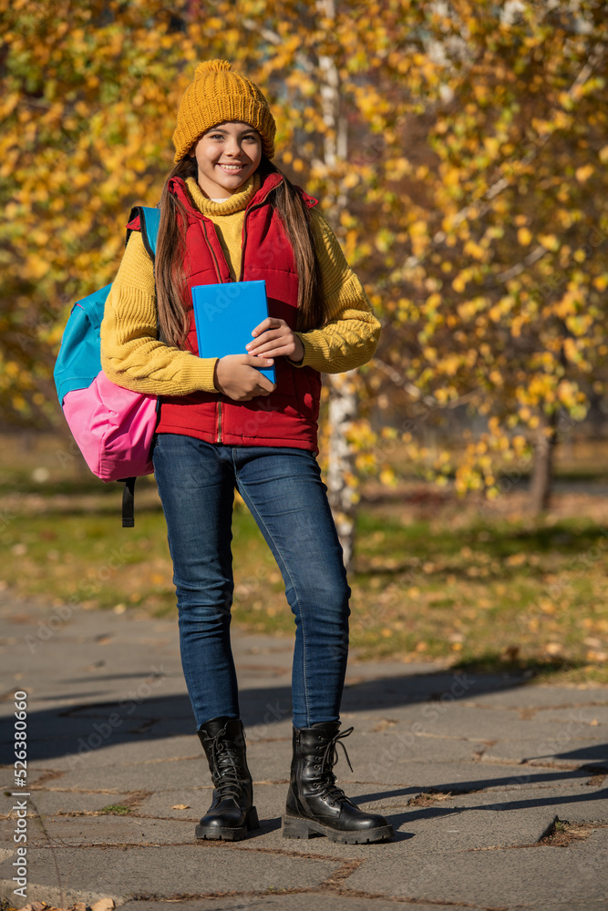 happy teen girl back to school in autumn. full length happy teen girl back to school in autumn. full length