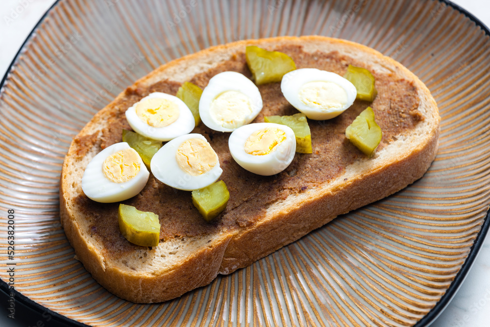 cracklings spread with pickled cucumber and boiled egg on slice of bread cracklings spread with pickled cucumber and boiled egg on slice of bread