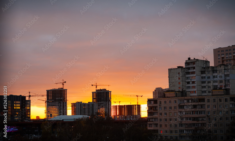 Ukraine city Kyiv. Construction of new high-rise buildings against the background of the evening sky.