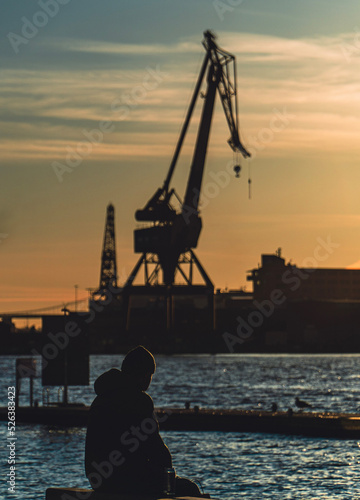 Guy in a bench looking the sunset in the city